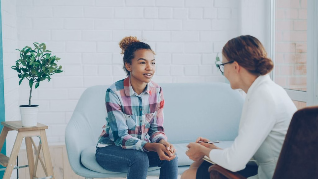Teen Mental Health Treatment - Stock image (pexels) of a female doctor and female teen speaking